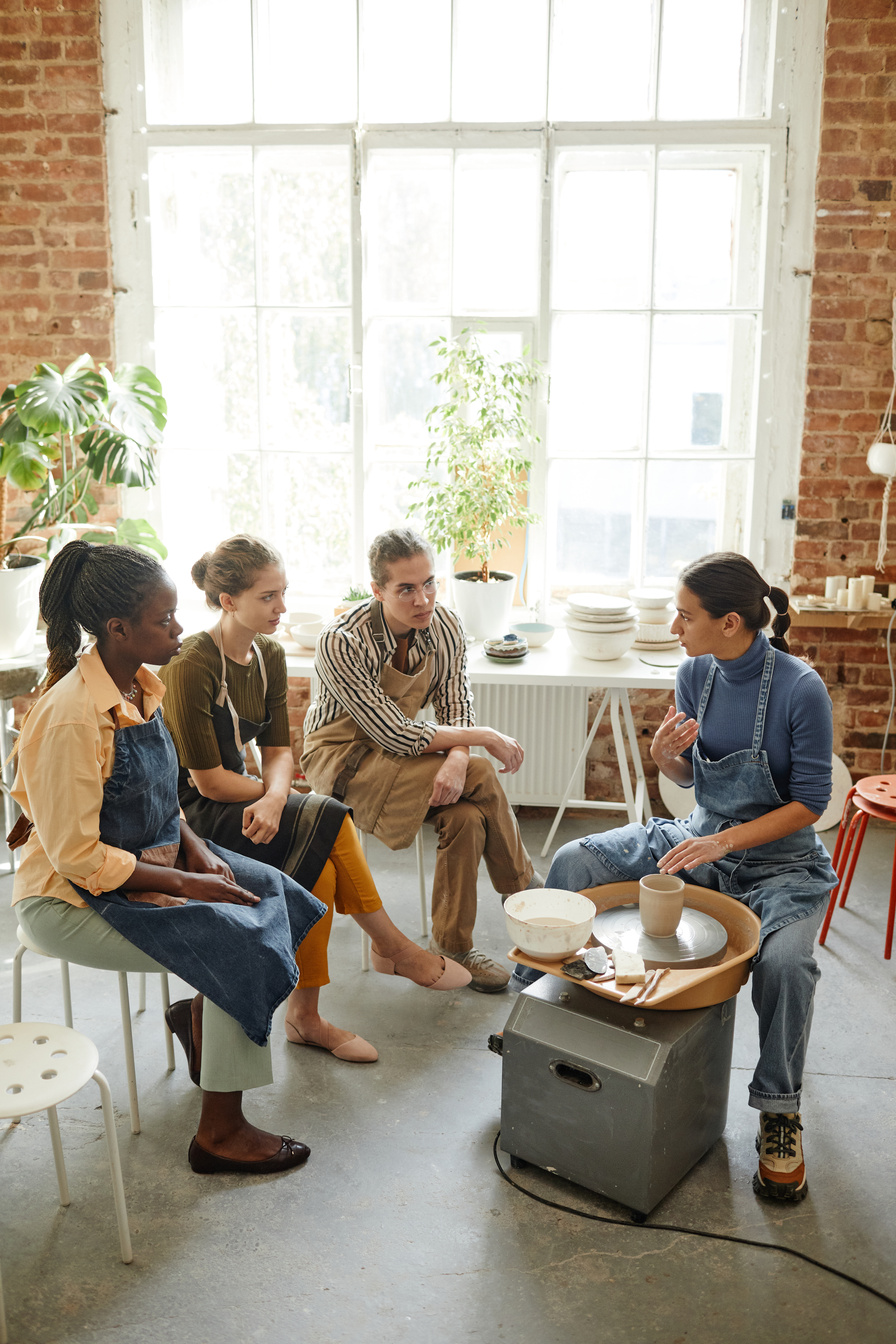 Group of People Listening to Female Potter in Workshop